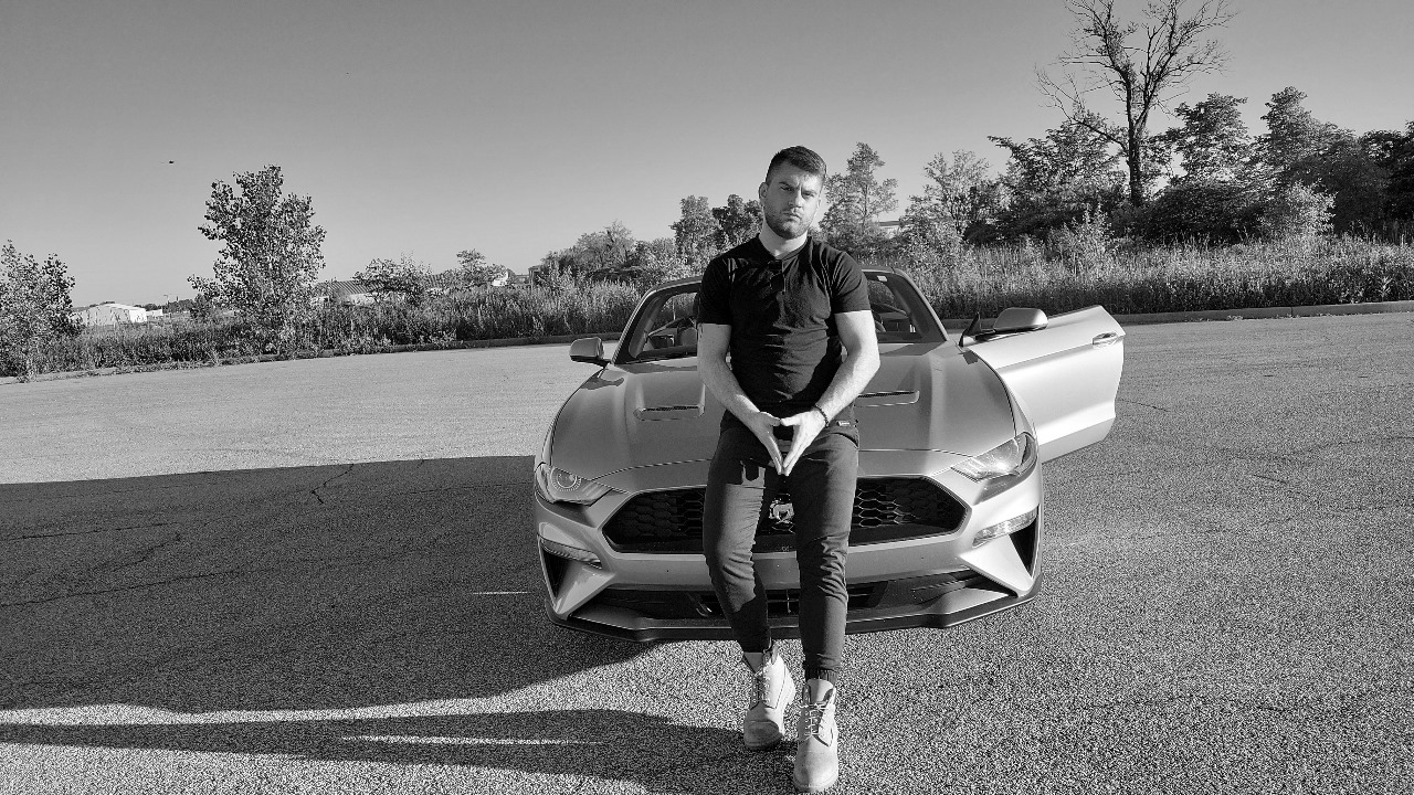 Nick Mendez Nicholas Mendez photo standing with a car